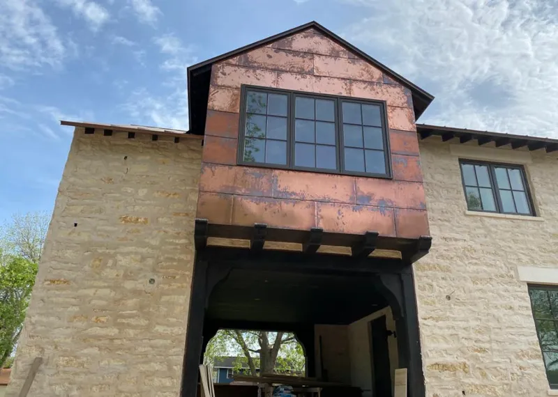 Copper metal panel facade on a stone building for Skylight Installation in Lynchburg, Moore County