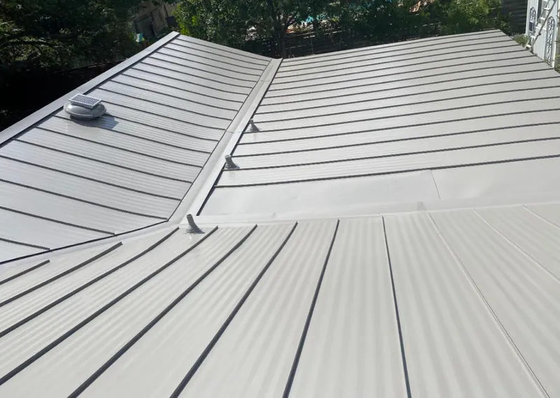 Solar attic fan installed on a metal roof for Roof Ventilation in Lynchburg, Moore County
