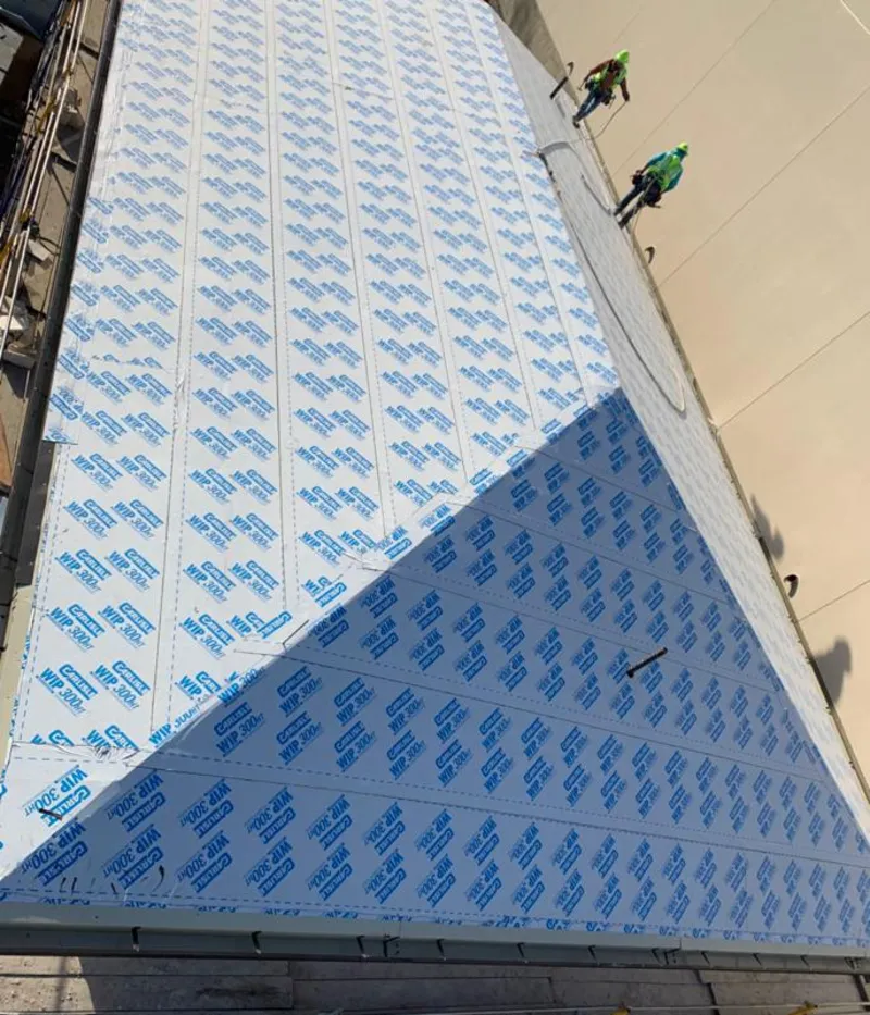 Professional roofers installing underlayment on a metal roof in Lynchburg, Moore County